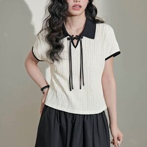 White textured top with black collar